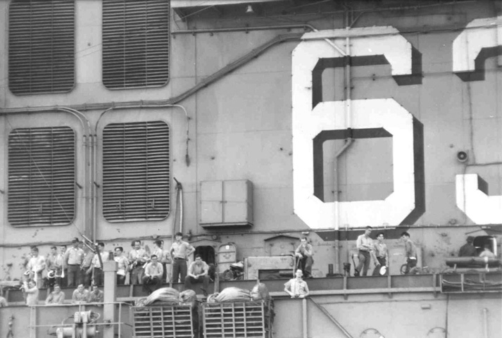 Spectators on the USS Kitty Hawk (CV 63)  during refueling with the USS Sproston (DD 577)